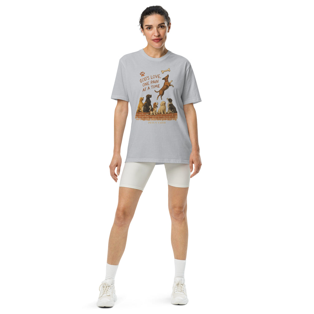 Woman wearing light gray Under Armour Pets N’ Faith Performance T-Shirts, front view with the graphic " God's Love, One Paw at A Time".