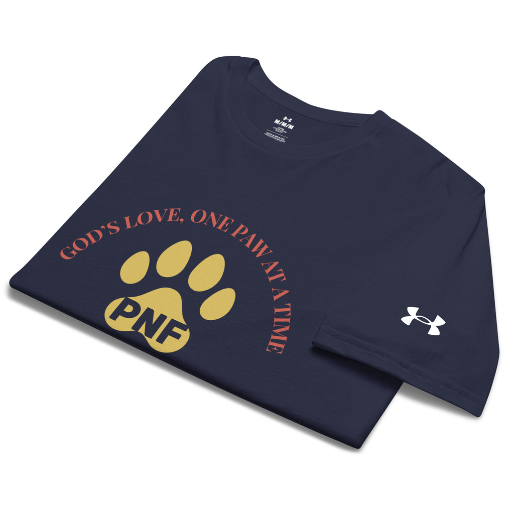 Folded navy blue Under Armour Pets N’ Faith Performance T-Shirt with “ God's Love, One Paw at A Time” design and Under Armour sleeve logo. The PNF initals are inside a gold paw print in the center of the shirt.