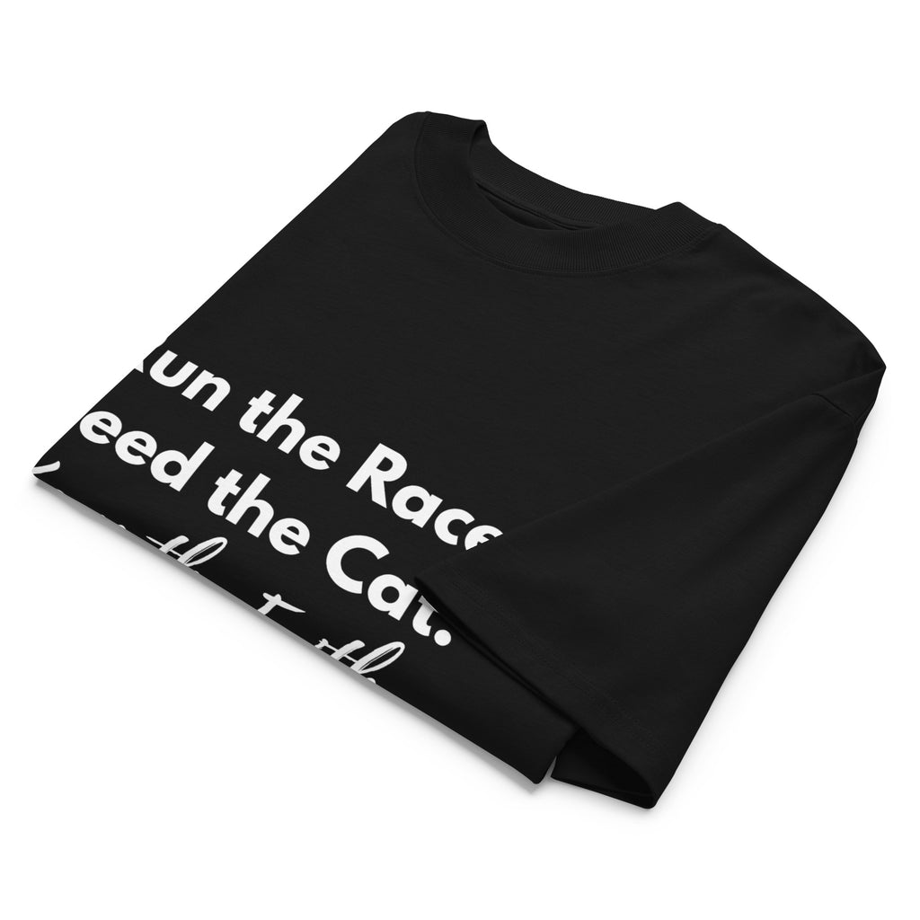 Folded black oversized Pets N Faith t-shirt with faith-inspired slogan partly visible
