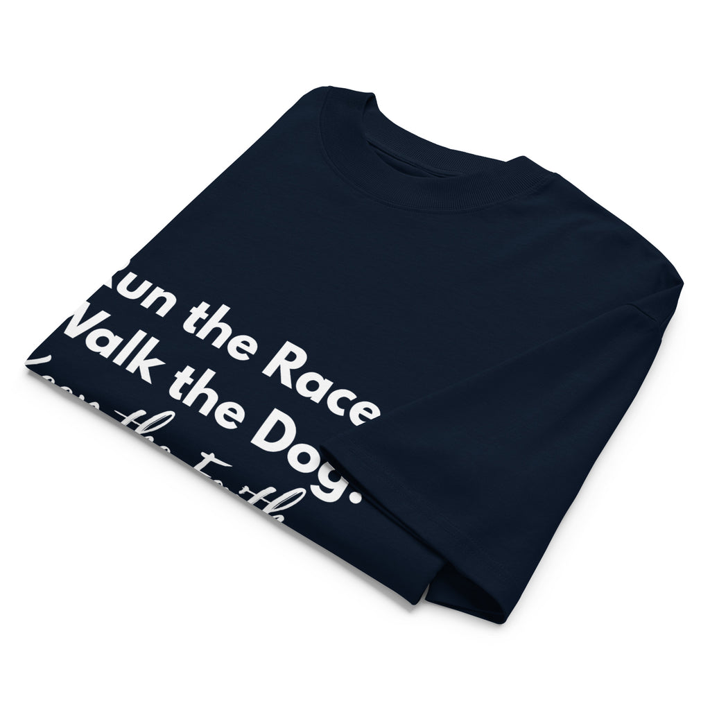 Folded navy oversized Pets N Faith t-shirt with faith-inspired slogan partly visible