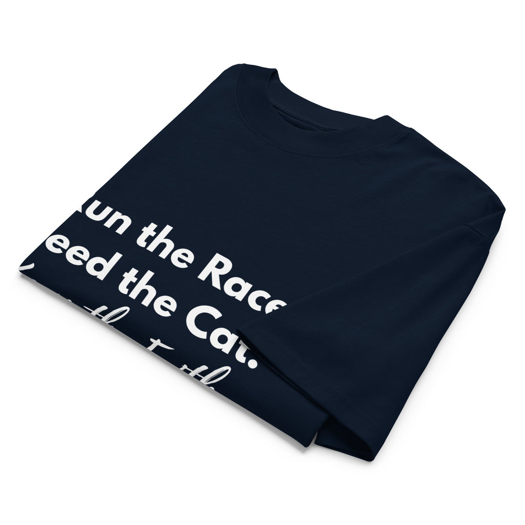 Folded navy oversized Pets N Faith t-shirt with faith-inspired slogan partly visible