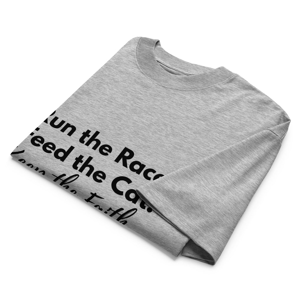 Folded khaki oversized Pets N Faith t-shirt with faith-inspired slogan partly visible