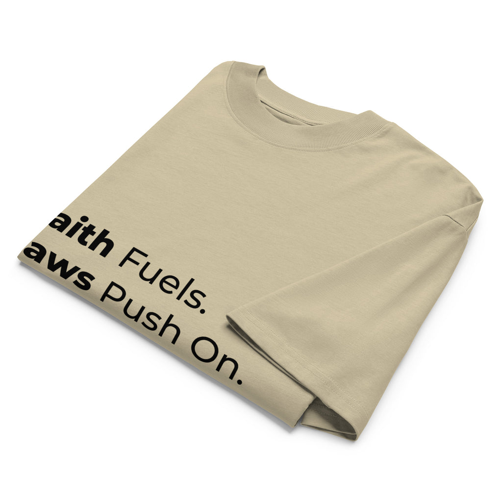 Folded khaki oversized Pets N Faith t-shirt with faith-inspired slogan partly visible