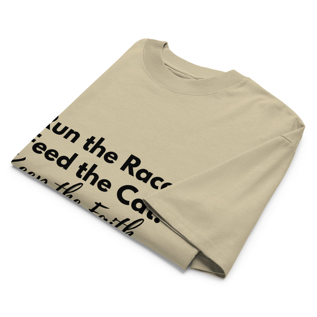 Folded khaki oversized Pets N Faith t-shirt with faith-inspired slogan partly visible
