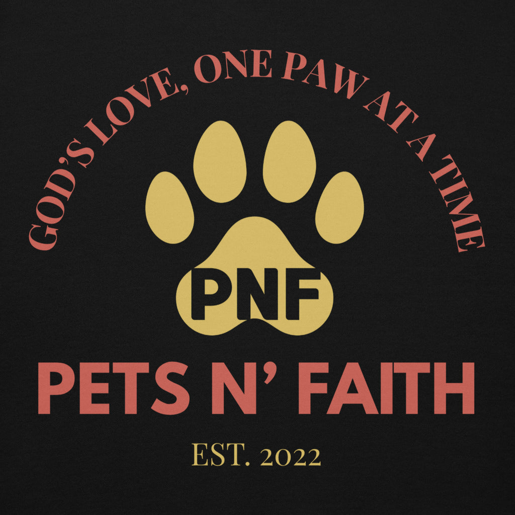 Close-up of yellow paw print logo and red “Pets N’ Faith” text on black hoodie