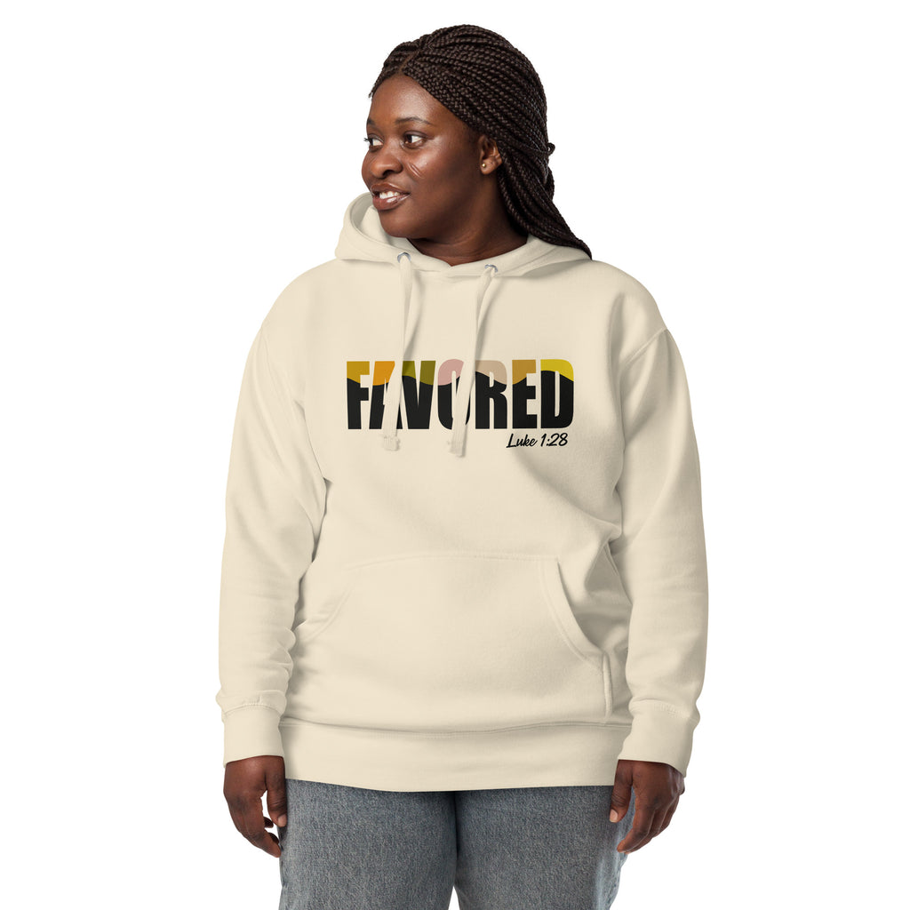 Woman wearing cream-colored Unisex Pets N’ Faith “Favored – Luke 1:28” Hoodie, front view