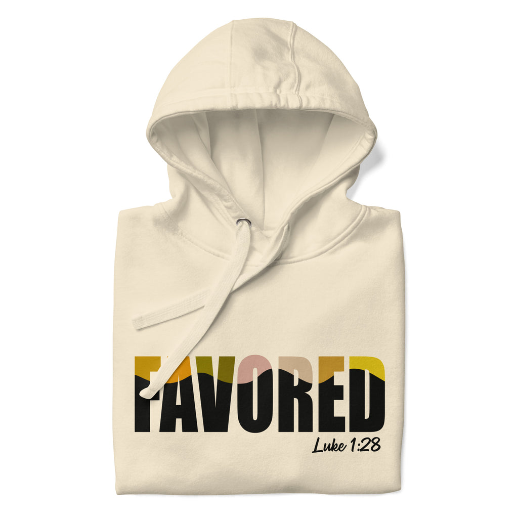 Folded cream-colored Unisex Pets N’ Faith Hoodie with multicolor “Favored” text and Luke 1:28 Bible verse
