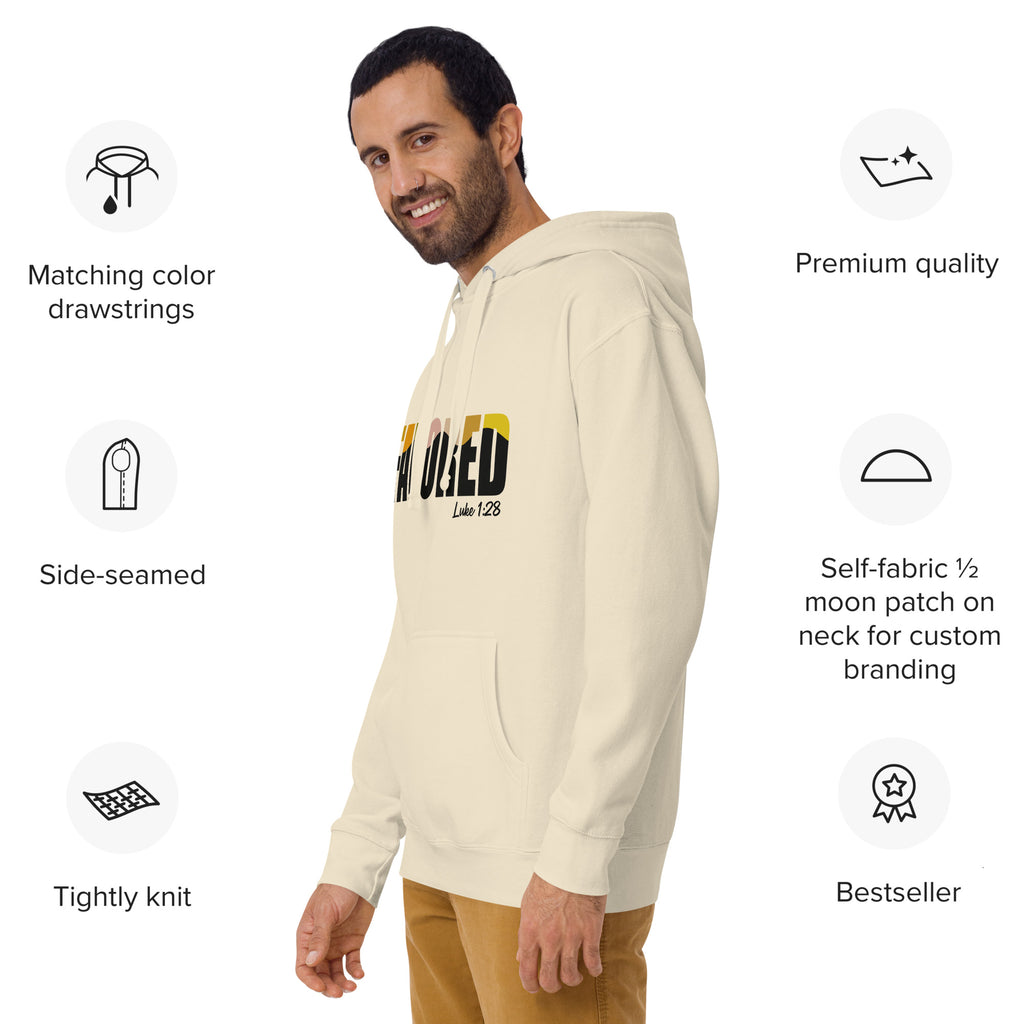 Man wearing cream-colored Unisex Pets N’ Faith “Favored – Luke 1:28” Hoodie, side view with product feature icons