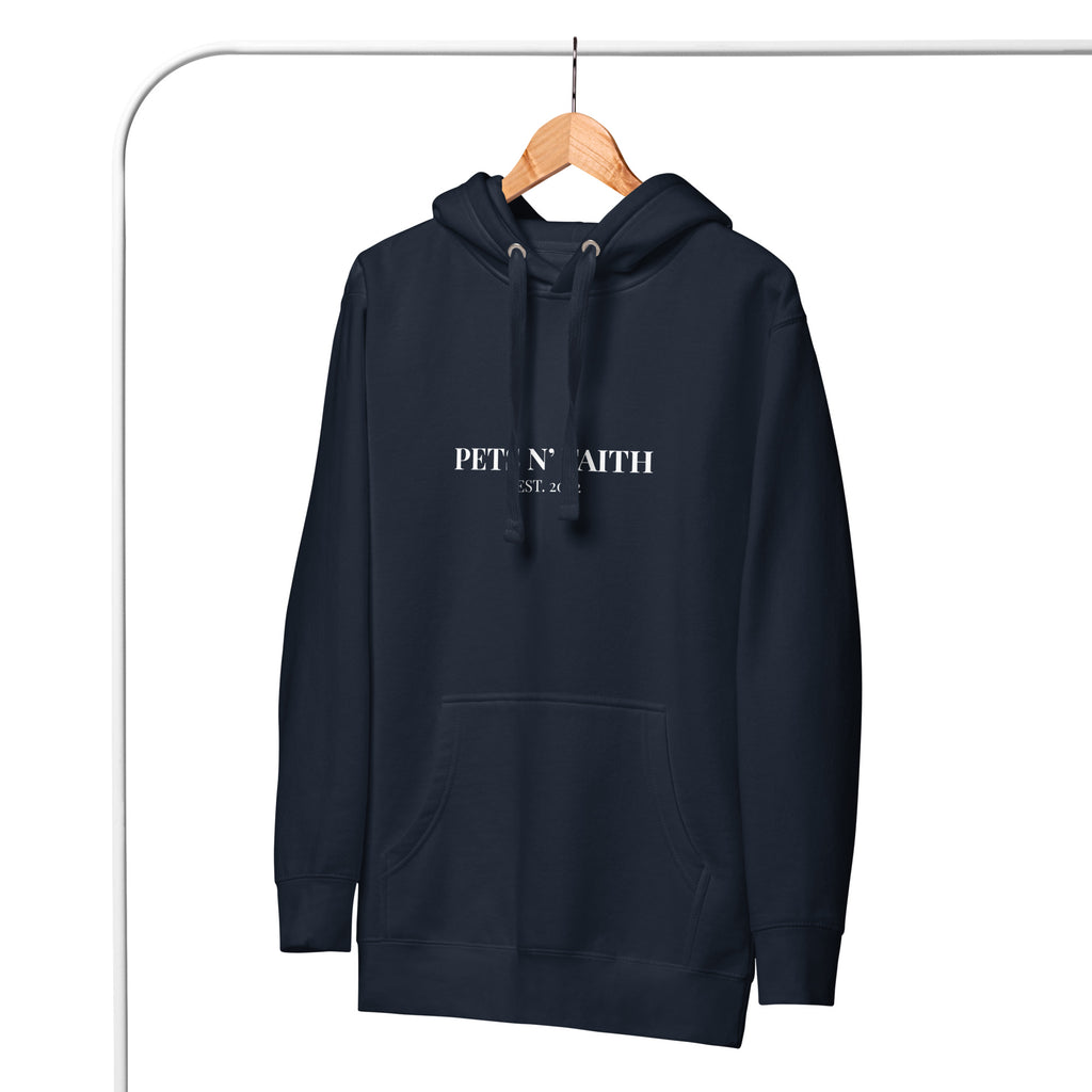 Front view of navy blue Unisex hoodie with Pets N’ Faith  Est 2022  in white text hanging on a wooden hanger