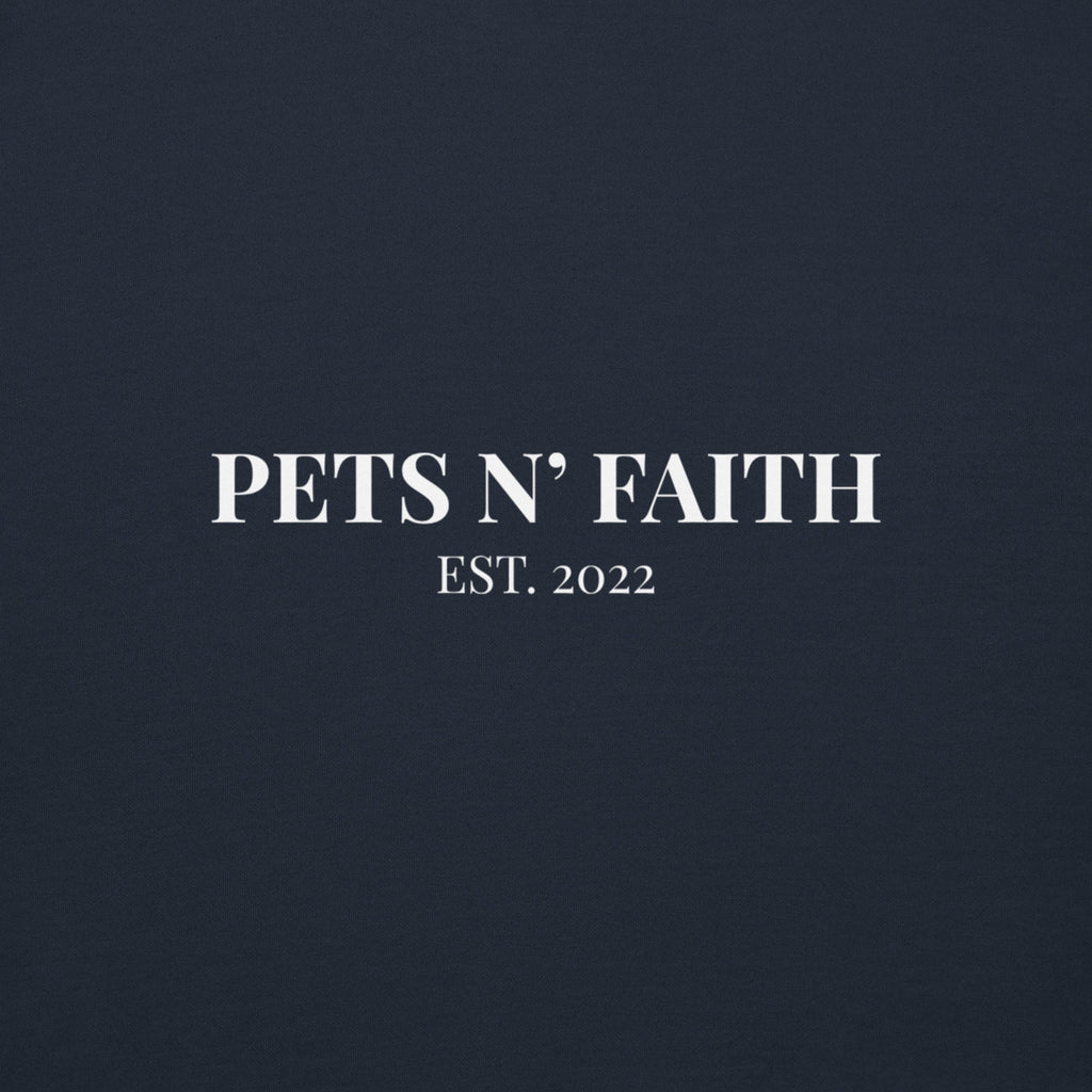Close-up of white Pets N' Faith Est. 2022 logo on navy blue hoodie