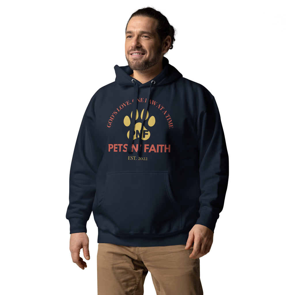 Man wearing navy Unisex Pets N’ Faith “God’s Love, One Paw at a Time” hoodie, showing matching color drawstrings 