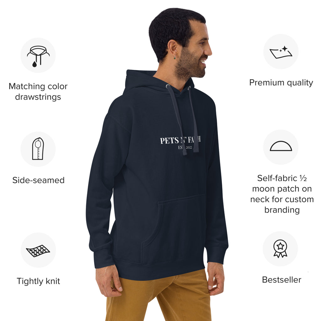 Man wearing navy blue Unisex Pets N’ Faith Est. 2022 hoodie, showing matching color drawstrings and premium quality icons.