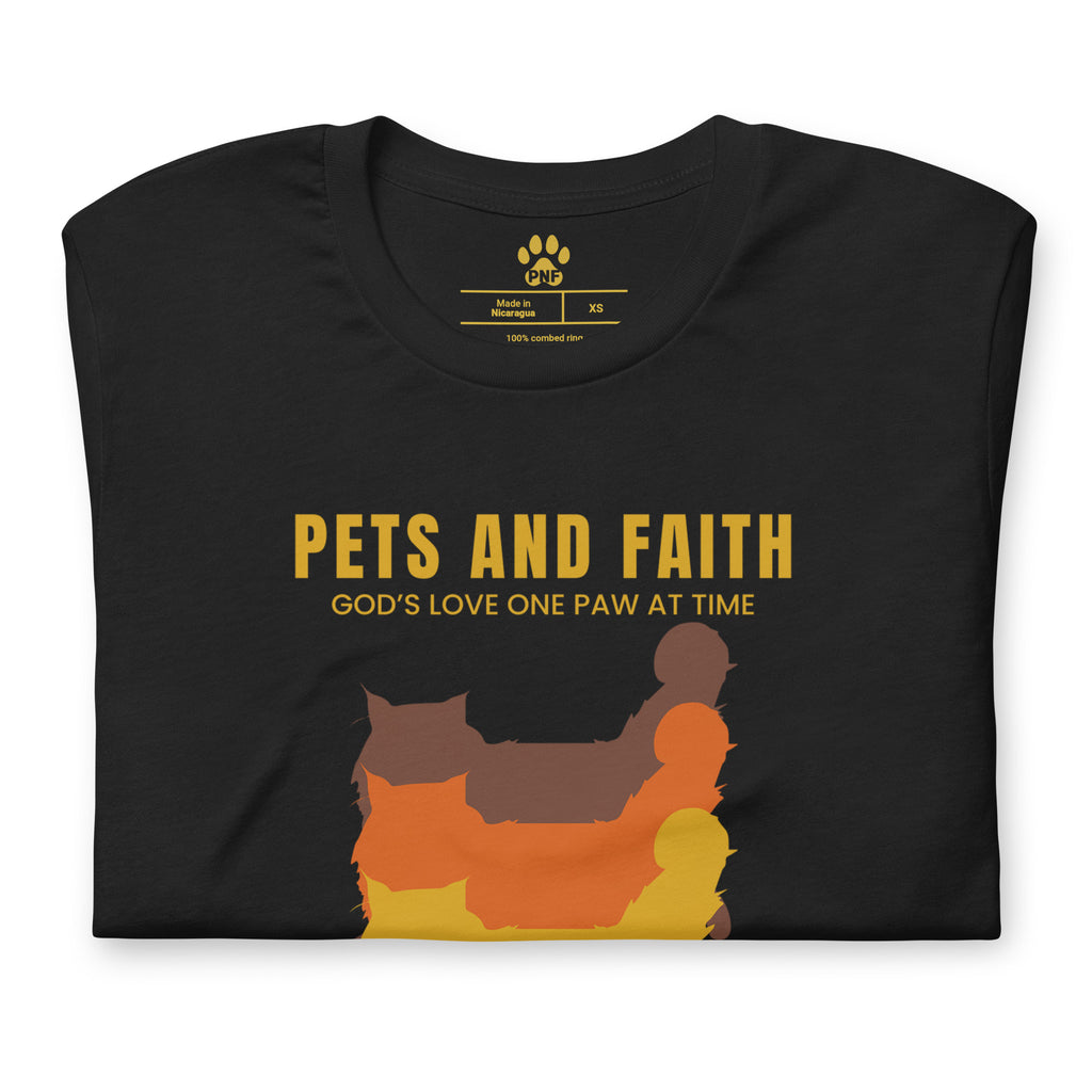 Folded view of Black Pets N Faith unisex cat t-shirt with ‘God’s Love One Paw at a Time’ text and layered cat silhouette design