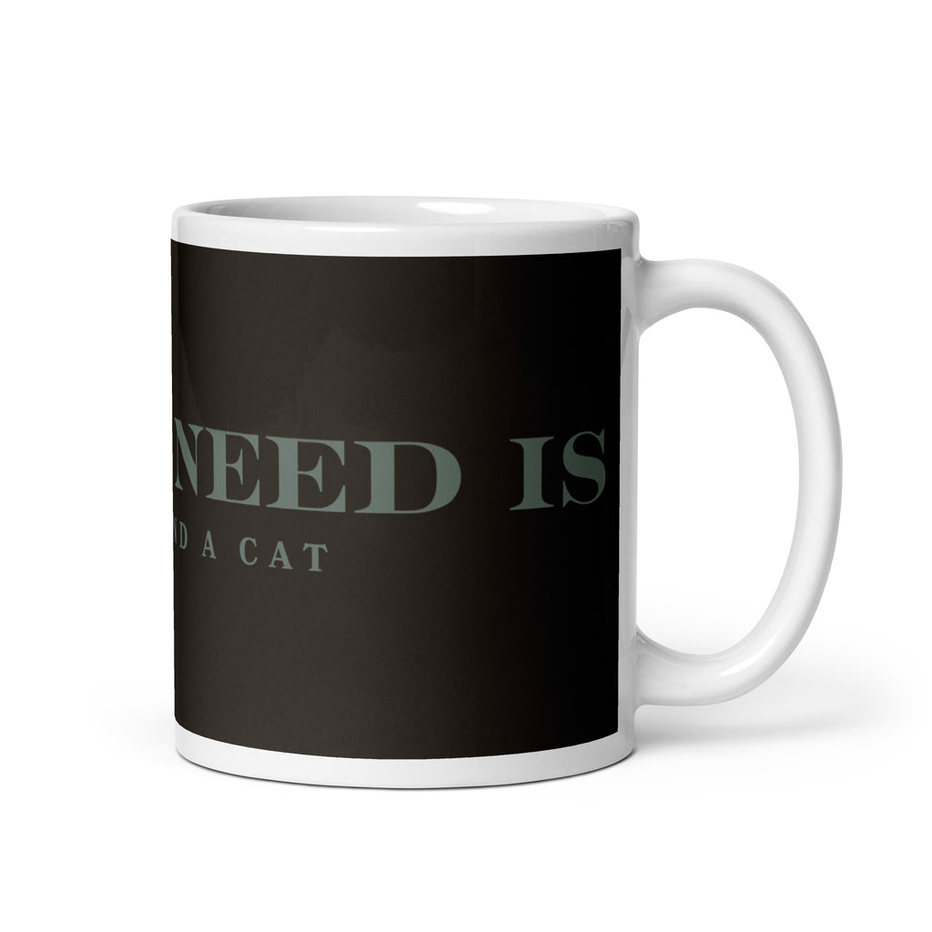A white glossy mug with the graphic stating, " All You Need is Coffee and A Cat" 