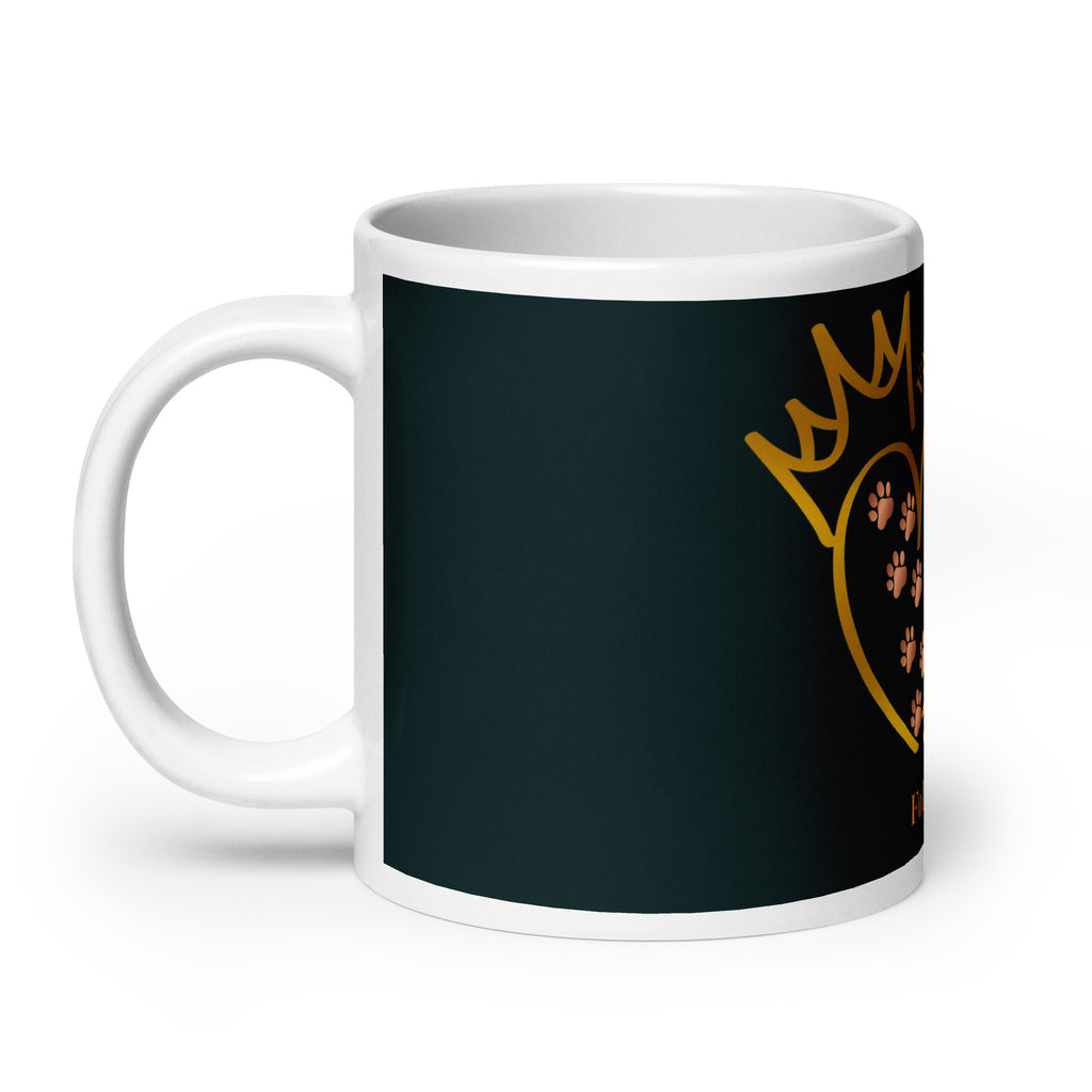 Side view of white glossy mug with a teal background. The graphic is a gold heart with a gold crown on top. The phrase is, " Favored by Jesus, Followed by Paw prints".  Small pet paw prints are walking through the heart graphic. 